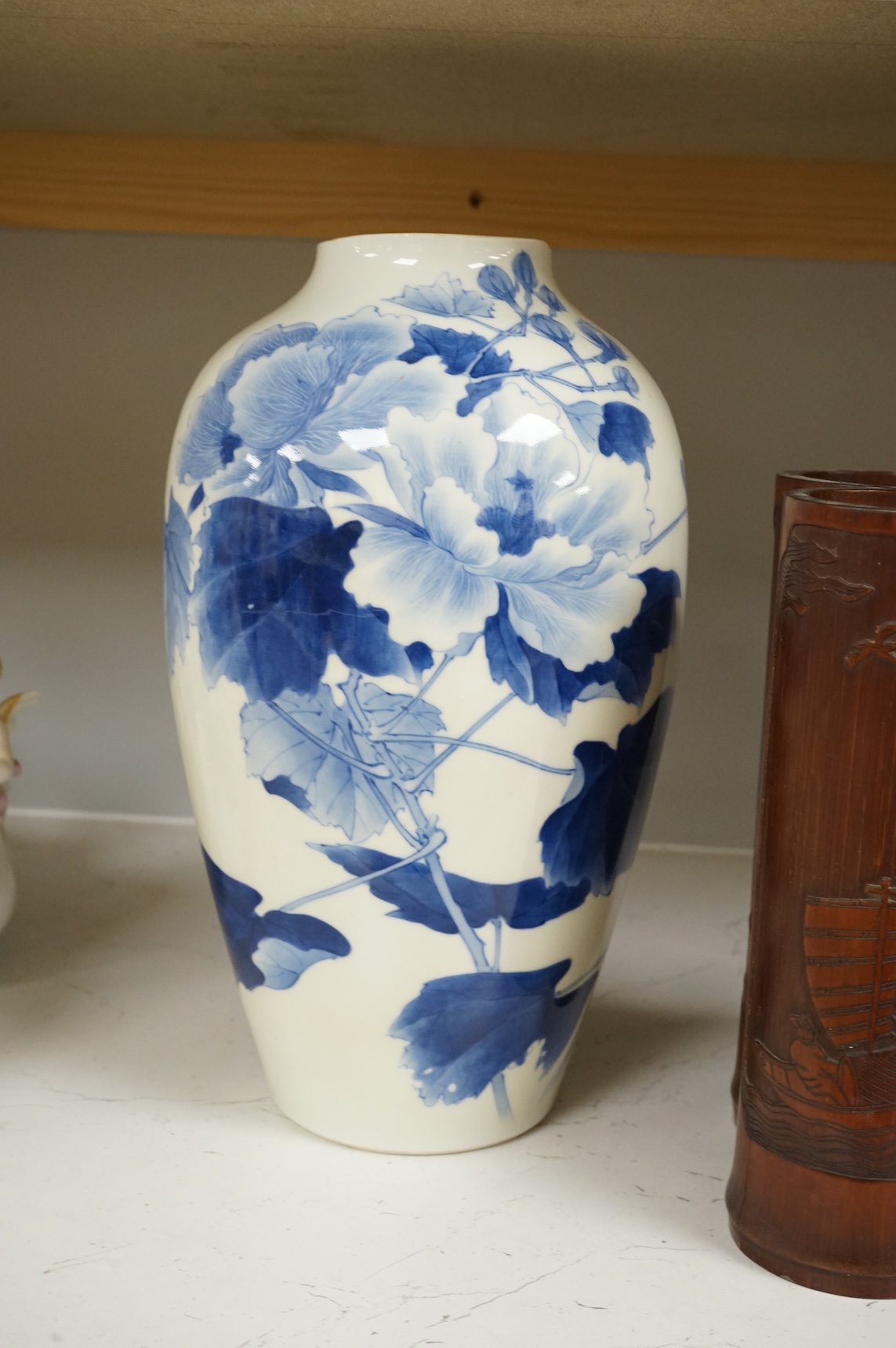 A Chinese Revolution Period porcelain bird group, 21.5cm, a pair of Chinese bamboo brushpots carved with figures and junks, each 22cm high, and a Japanese Seto blue and white vase, 29cm high